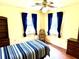 Bedroom featuring hardwood floors, windows and built-in bookshelf at 3575 Lake Highland Dr, Palm Harbor, FL 34683
