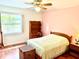 Bedroom featuring hardwood floors, large windows, and ceiling fan at 3575 Lake Highland Dr, Palm Harbor, FL 34683