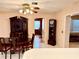 View of the dining room with table, china cabinet, and a decorative grandfather clock at 3575 Lake Highland Dr, Palm Harbor, FL 34683