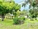 Charming single-story home with lush landscaping, welcoming front porch, and a fenced-in yard at 3575 Lake Highland Dr, Palm Harbor, FL 34683