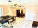 Open-concept living room with tile flooring, ceiling fan, and seamless flow into the dining area at 3575 Lake Highland Dr, Palm Harbor, FL 34683