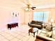 Inviting living room features tile flooring, ceiling fan, and ample natural light with comfortable seating at 3575 Lake Highland Dr, Palm Harbor, FL 34683