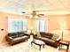 Bright living room features tile flooring and ceiling fan, offering a cozy seating area with natural light at 3575 Lake Highland Dr, Palm Harbor, FL 34683
