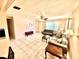 Inviting living room featuring tile flooring, ceiling fan, and comfortable seating with an open floorplan at 3575 Lake Highland Dr, Palm Harbor, FL 34683
