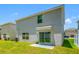 A home's exterior with a sliding glass door and grassy backyard at 36652 N Spanish Rose Dr, Dade City, FL 33525