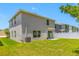Spacious backyard featuring a well-maintained lawn, white fence, and the home's neutral exterior at 36652 N Spanish Rose Dr, Dade City, FL 33525