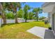 Spacious backyard featuring lush green grass, mature trees, and a pristine white privacy fence for added seclusion at 36652 N Spanish Rose Dr, Dade City, FL 33525