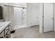 A bathroom with tile floor, shower and white cabinets at 36652 N Spanish Rose Dr, Dade City, FL 33525