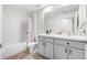 A bathroom with double sinks, bath tub with shower, and tile floor at 36652 N Spanish Rose Dr, Dade City, FL 33525