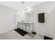 A bathroom with double sinks, tile floor, white cabinets, and a towel bar at 36652 N Spanish Rose Dr, Dade City, FL 33525