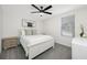 Charming bedroom with neutral carpet, white bedding, a window, and a ceiling fan at 36652 N Spanish Rose Dr, Dade City, FL 33525