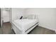 Bedroom features neutral carpet, white bedding, and good natural light at 36652 N Spanish Rose Dr, Dade City, FL 33525