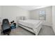 Bedroom features neutral carpet, white bedding, a window, and gym equipment at 36652 N Spanish Rose Dr, Dade City, FL 33525