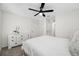 Bright bedroom features neutral carpet, white bedding, white dresser and a ceiling fan at 36652 N Spanish Rose Dr, Dade City, FL 33525