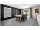 Dining room with a large farmhouse table and decorative black accent wall at 36652 N Spanish Rose Dr, Dade City, FL 33525