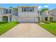 Charming home featuring a two-car garage, beautiful landscaping, and a welcoming front porch at 36652 N Spanish Rose Dr, Dade City, FL 33525