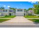 A full shot of the home surrounded by lush green grass and beautiful landscaping at 36652 N Spanish Rose Dr, Dade City, FL 33525