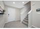 Welcoming foyer with a white front door, tile floors, and a staircase leading upstairs at 36652 N Spanish Rose Dr, Dade City, FL 33525