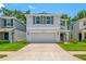 Charming home featuring a two-car garage, beautiful landscaping, and a welcoming front porch at 36652 N Spanish Rose Dr, Dade City, FL 33525