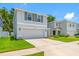 Beautiful home featuring a two-car garage and welcoming front porch and landscaping at 36652 N Spanish Rose Dr, Dade City, FL 33525