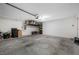 Well-lit garage with storage racks and ample space for a vehicle and other belongings at 36652 N Spanish Rose Dr, Dade City, FL 33525