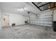 Bright garage with a large door, offering ample space for vehicles and storage at 36652 N Spanish Rose Dr, Dade City, FL 33525