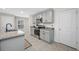 Well-lit kitchen with gray cabinetry, granite countertops, and stainless steel appliances at 36652 N Spanish Rose Dr, Dade City, FL 33525