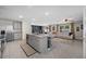 Modern kitchen featuring gray cabinetry, stainless steel appliances, and an island with bar seating at 36652 N Spanish Rose Dr, Dade City, FL 33525