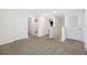 Carpeted upstairs landing featuring multiple doorways leading to bedrooms and bathrooms at 36652 N Spanish Rose Dr, Dade City, FL 33525