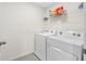 Convenient laundry room with a washer and dryer, plus shelving to store detergent and supplies at 36652 N Spanish Rose Dr, Dade City, FL 33525