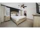 A main bedroom with dark accent wall, ceiling fan, and walk in closet at 36652 N Spanish Rose Dr, Dade City, FL 33525