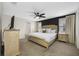 The main bedroom features an accent wall, a ceiling fan, carpet and windows at 36652 N Spanish Rose Dr, Dade City, FL 33525