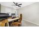 Bright home office featuring a ceiling fan, wood desk, and comfortable tan leather office chair at 36652 N Spanish Rose Dr, Dade City, FL 33525