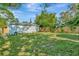 Large, grassy backyard with privacy fence, offering ample space for outdoor enjoyment at 3714 N Garrison St, Tampa, FL 33619
