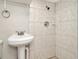 Bathroom with pedestal sink and shower at 3714 N Garrison St, Tampa, FL 33619
