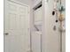 Tiled walk-in shower with shelving; bathroom includes a washer and dryer at 3714 N Garrison St, Tampa, FL 33619