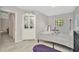 Sun-filled bedroom with light floors, accent rug, and a cabinet for storage at 3714 N Garrison St, Tampa, FL 33619