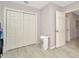 Cozy bedroom featuring storage with a closet and an adjacent bathroom for convenience at 3714 N Garrison St, Tampa, FL 33619