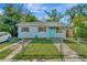 Charming single-story home featuring a fenced yard and a quaint, welcoming curb appeal at 3714 N Garrison St, Tampa, FL 33619