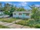 Charming single-story home with a well-maintained front yard and a bright blue front door at 3714 N Garrison St, Tampa, FL 33619