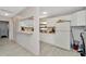 Bright kitchen with white cabinets, light counters, microwave, refrigerator and tile floors at 3714 N Garrison St, Tampa, FL 33619