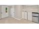 Bright laundry room features tile floors, ample storage, and a convenient stainless steel mini fridge at 3714 N Garrison St, Tampa, FL 33619
