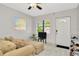 Cozy living room features neutral paint, ceiling fan, light tile floors and lots of natural light at 3714 N Garrison St, Tampa, FL 33619