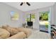 Open view from living room to front yard with large sofa and lots of natural light at 3714 N Garrison St, Tampa, FL 33619