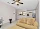 View from living room pass through showing light tile floors, comfortable seating and kitchen access at 3714 N Garrison St, Tampa, FL 33619
