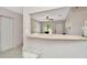 Kitchen pass through to the living room featuring tile floors, white cabinets, and stainless steel appliances at 3714 N Garrison St, Tampa, FL 33619
