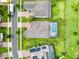 Aerial view of a beautiful home with a screened-in pool, complemented by lush landscaping and a well-maintained yard at 4080 Bonfire Dr, Odessa, FL 33556