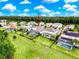 Aerial view of a lovely property featuring a screened-in pool, bordered by an elegant fence and lush greenery at 4080 Bonfire Dr, Odessa, FL 33556