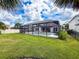 Large backyard featuring a pool with screened enclosure, palm trees, and privacy fencing at 4080 Bonfire Dr, Odessa, FL 33556