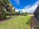 Well-maintained backyard with lush grass, privacy fence, and mature trees at 4080 Bonfire Dr, Odessa, FL 33556